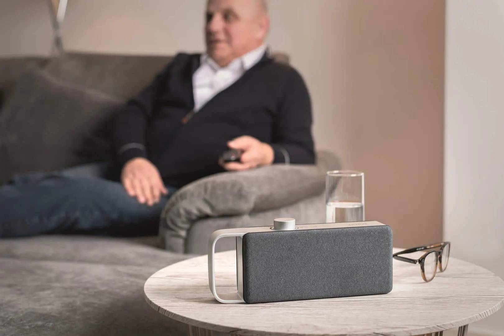 Man in armchair in the foreground TV voice amplifier OSKAR